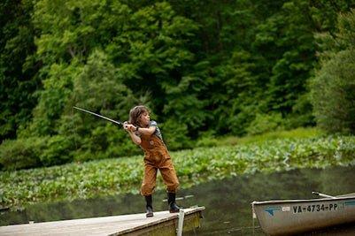 Child casting from dock