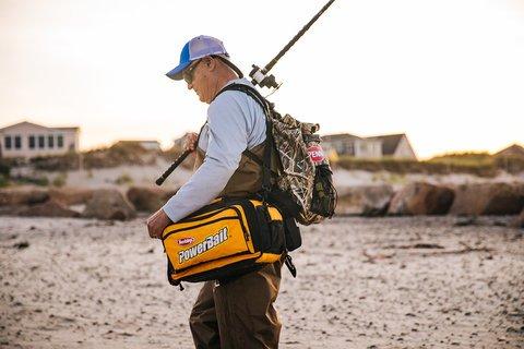 Angler carrying supplies on beach