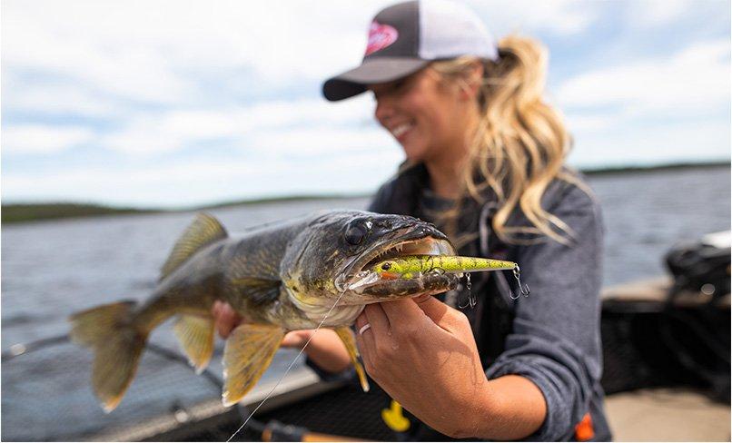 Angler holding fish with bait in mouth