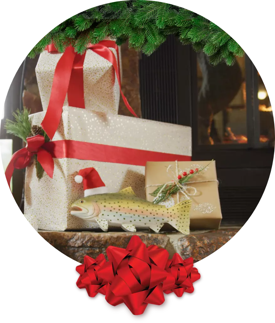 Presents underneath a tree including a wooden fish with a Santa hat