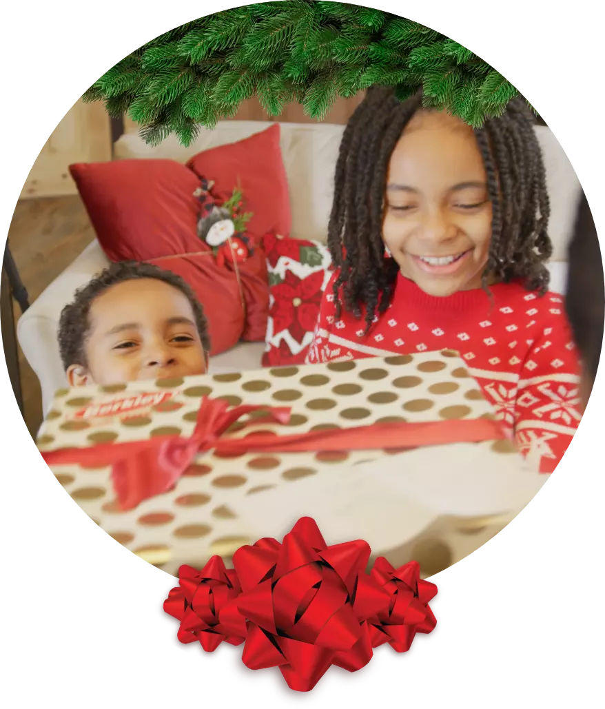 Two children opening a gift wrapped with Berkley wrapping paper